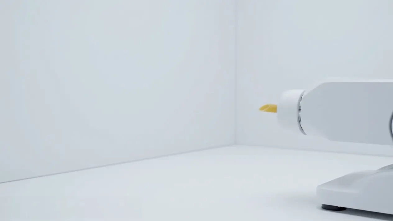 Robotic arm launching penne pasta at a wall — workplace burnout metaphor.